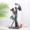 Couple under umbrella statue